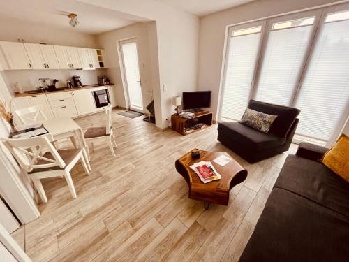 a living room with a couch and a table at Ferienwohnungen Mey Haus zum Rosenstock in Erfurt