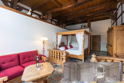 a living room with a red couch and a bed at Landhotel Der Buchenhof Bad Essen in Bad Essen
