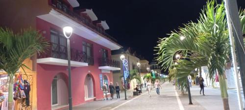 a street at night with people walking down the street at Residencial Ilha do Fogo app 205 in Santa Maria