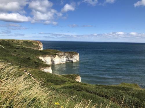 a view of the ocean with cliffs and the ocean at Arthurs Escape in Filey