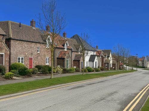 a row of brick houses on a street at Arthurs Escape in Filey