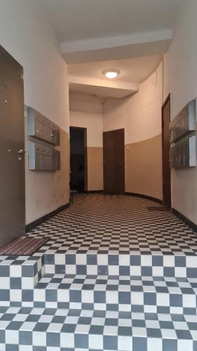 an empty room with a checkered floor at Center apartment Great Amber in Liepāja