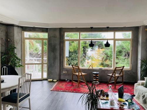 a living room with a table and chairs at Island House in Adalar