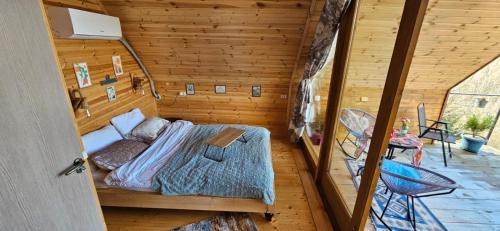 a bedroom with a bed in a wooden room at LIMA in Kutaisi