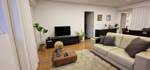 a living room with a couch and a tv at Casa Filó in Peso da Régua