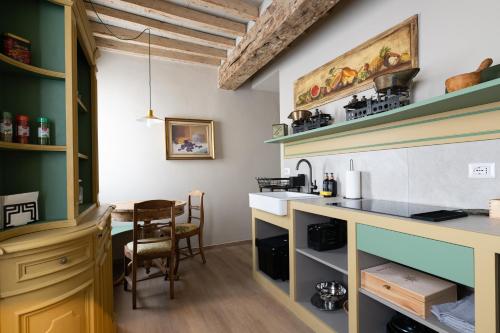 a kitchen with a sink and a table at Borgo35 in Parma