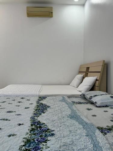 a bedroom with a bed with a blanket on it at Home Sun Moon - Phòng Đôi in Phan Thiet