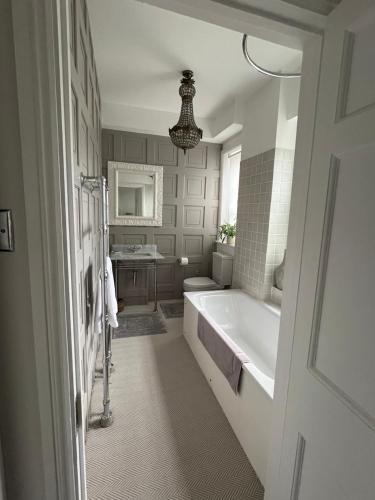 a bathroom with a bath tub and a sink at The Georgian House in London