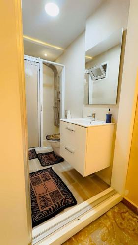 a bathroom with a sink and a shower and a toilet at Luxury in Tétouan