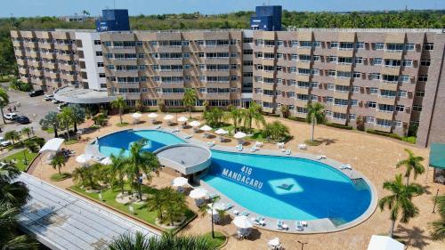 an aerial view of a hotel with a swimming pool at Barreirinhas Gran Lençóis Flat in Barreirinhas