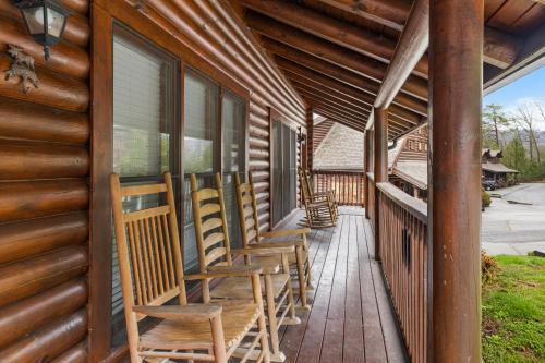 a porch with rocking chairs on a log cabin at Golf View cabin in Pigeon Forge