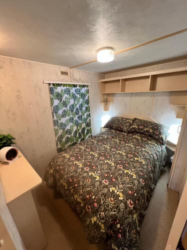 a bedroom with a bed in a small room at City Caravan, 5 mins from Cardiff city centre, Dog Friendly and perfect weekend Getaway in Cardiff