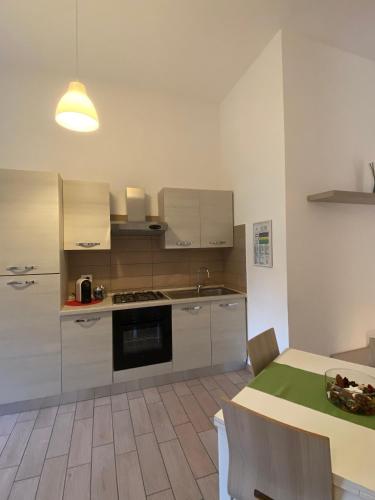 a kitchen with stainless steel appliances and a table at Case Vacanze Ganimede in Sperlonga