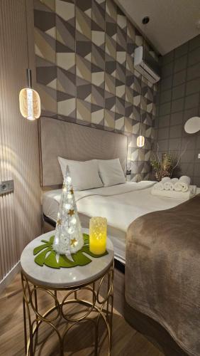 a hotel room with a bed and a table with a christmas tree at Lounge garden sea relax in Valencia