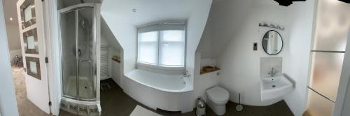 a bathroom with a shower and a toilet and a sink at The Loft in London