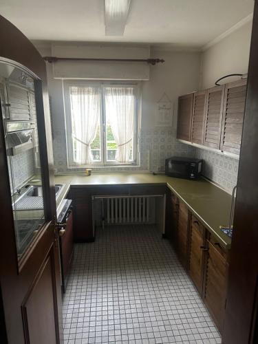 an empty kitchen with a sink and a window at Zimmer in Oberhausen