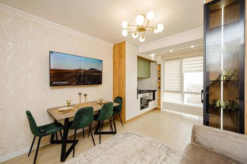 a living room with a dining room table and chairs at Decebal Apartment in Chişinău