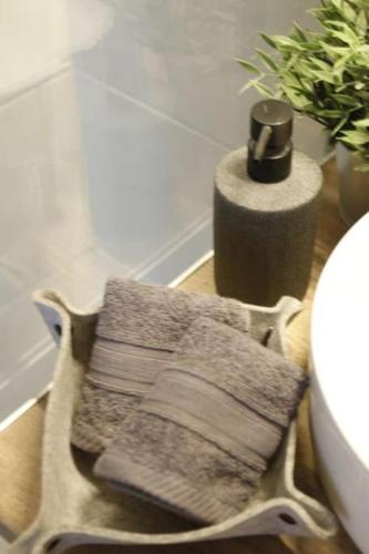 a basket with towels on a floor next to a sink at Central House in Plaka in Athens