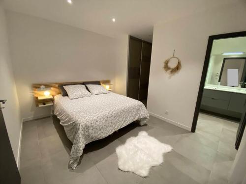 1 dormitorio con cama y espejo grande en Maison Appart, Le Cocon Brindasien, 20 min de Lyon, 66 m2, en Brindas