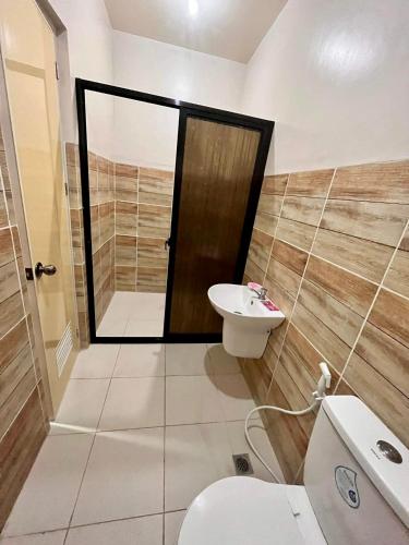 a bathroom with a toilet and a sink at Shing Spa Resort in Brooke's Point