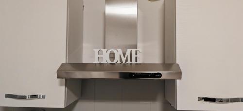 a sink in a bathroom with a sign on it at La casa di Luca B&B in Lacchiarella
