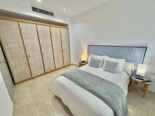 a bedroom with a large white bed with pillows at ApartSur® in Bormujos