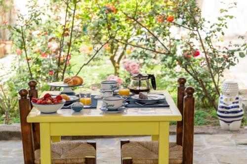 a yellow table with breakfast food on it at Villa il Turro in Massa Lubrense