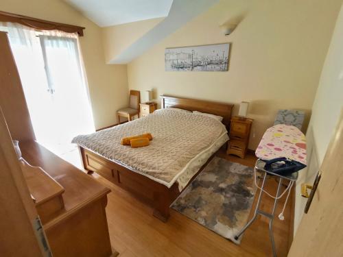 a small bedroom with a bed and a chair at Apartmani Kenova 5 in Herceg-Novi