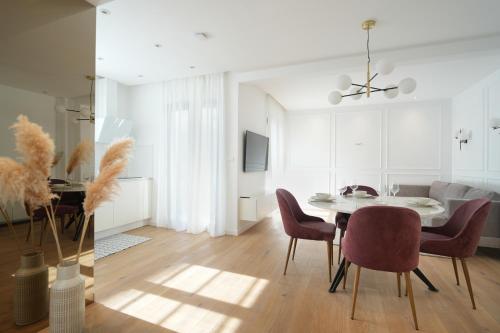a dining room with a table and chairs at Adria Concept Suites in Zadar