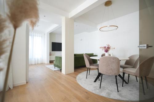 a dining room and living room with a table and chairs at Adria Concept Suites in Zadar