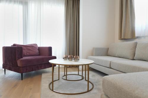 a living room with a couch and a table at Adria Concept Suites in Zadar