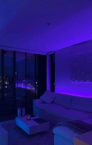 a living room with a couch and purple lighting at Ysso3 in Taif