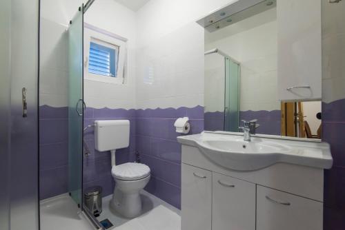 a bathroom with a toilet and a sink at Vila Niko Dalmacija in Sukošan