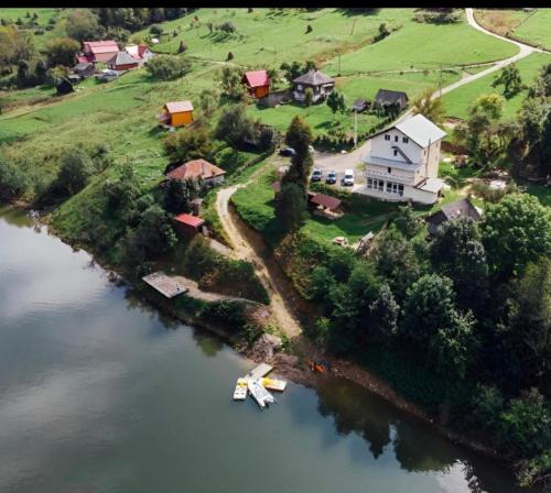 an aerial view of a house on an island in the water at Casa Pescarului Apuseni in Sohodol