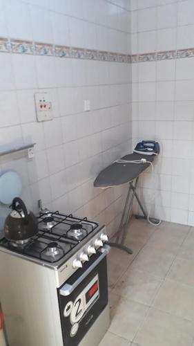 a kitchen with a stove and a table in it at OD-V!CK'S LUXE, WUSE DISTRICT, Swimming Pool, Gym, WiFi, 24hr power, security, Dstv in Abuja