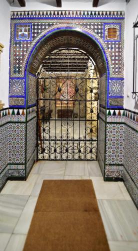a gate in a building with a rug on the floor at Suite Doña Inés Barrio Santacruz in Seville