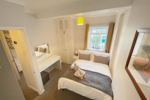 a small bedroom with a bed and a window at Torquay in Torquay