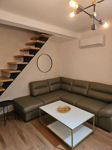 a living room with a couch and a table at Apartments Vraneš Tivat in Tivat
