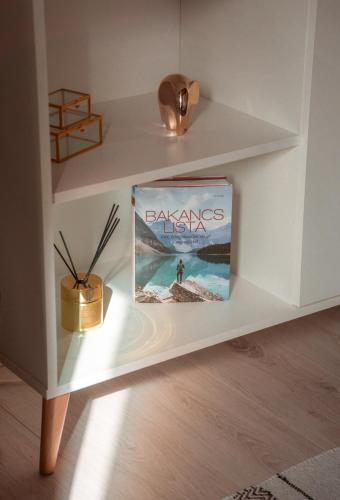 a book sitting on a shelf in a room at Somló Nordic in Somlószőlős
