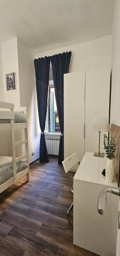 a room with a bed and a desk and a bedroom at La Passeggiata in Monterotondo