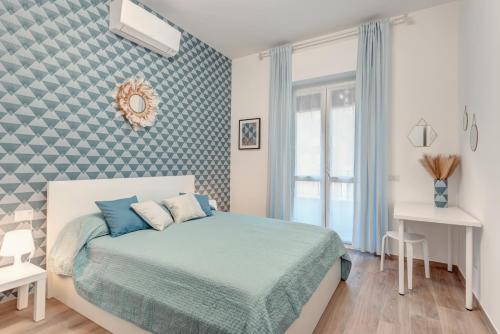 a bedroom with a bed with blue sheets and a window at La Culla di Milano in Milan