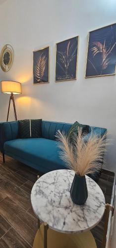 a living room with a blue couch and a table at La Passeggiata in Monterotondo