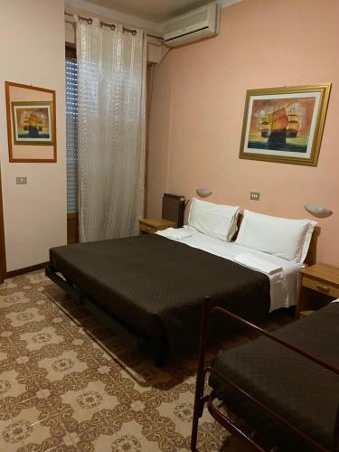 a bedroom with two beds and a window at Nuovo Hotel Attico in Chianciano Terme