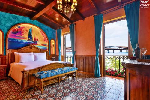 a bedroom with a bed and a large window at Venice Hotel Phu Quoc - Free Hon Thom Island Waterpark Cable Car & Sunset Town Tour in Phú Quốc