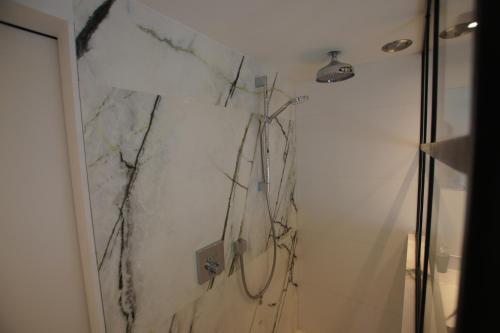 a bathroom with a marble wall and a shower at A - (frame) - Like A dream in Durbuy