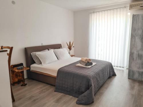 a bedroom with a bed with a hat on it at Lemon&Olives in Budva