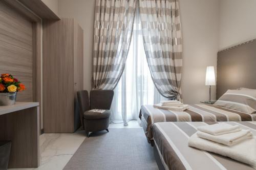 a hotel room with two beds and a window at Brera Prestige B&B in Milan