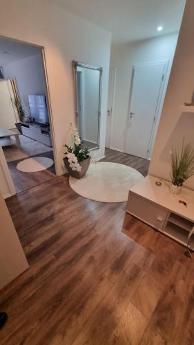 a living room with wood floors and a room with a tv at Apartman-Florianska in Košice