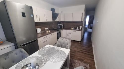 a kitchen with a refrigerator and a table and chairs at Apartman-Florianska in Košice