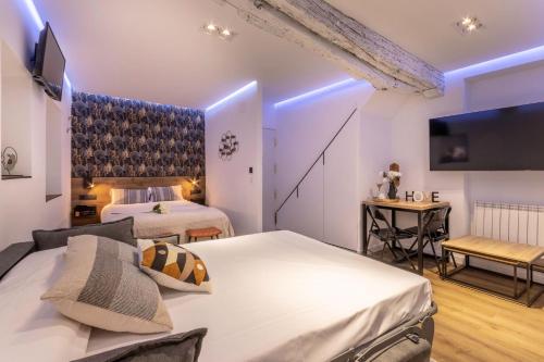 une chambre d'hôtel avec deux lits et une télévision dans l'établissement Suite Bermeo - Loft, à Bermeo